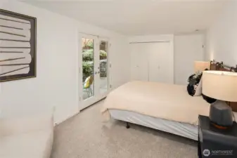 Downstairs secondary bedroom. French doors open to backyard patio space