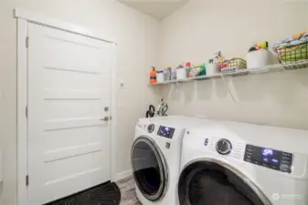 Laundry room with room for a freezer and access to the oversized 3 car garage.
