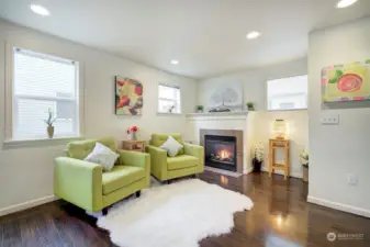 Cozy gas fireplace lights up this comfortable living room area