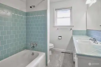 Main full bath with new LPV flooring.  Very soft colors which enhance the bathroom.