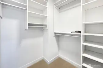 Primary closet is huge and features custom closet design