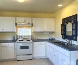 Inside is a bright and cheery kitchen with lots of counter space and cabinets.