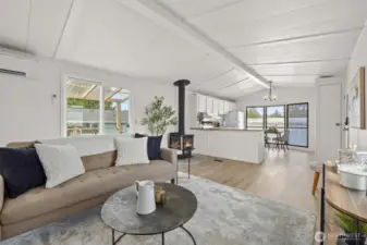 Living room offers fresh paint, LVP floors throughout and a wood burning fireplace.