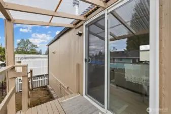 Covered back deck with access to the backyard, south facing.