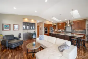 Living Room offers Vaulted ceilings, Acacia Floors, Entry point to deck via four panel french doors, Rock faced gas fireplace, and a wet bar.