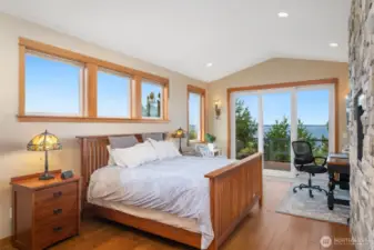 Primary Suite has an entry point to the spacious deck. a gas fireplace and fir trimmed windows that offer so much natural light.  Engineered cherry hardwood floors.