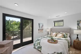 A bedroom on the upper floor with the deck access