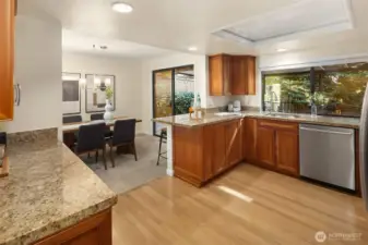 Dining area just off the kitchen featuring granite counters, stainless steel appliances, and plenty of cabinet space.
