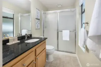 Master bedroom with remote operated low profile ceiling fan with light, French doors, large closet, and attached 3/4 bath.