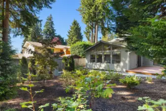 Landscaped backyard with paver walkway and storage shed.