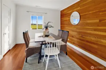 The large dining room features a wood accent wall