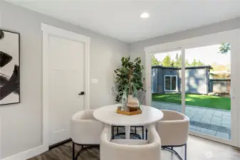 Cozy dining nook with  sliding glass doors that open to a spacious backyard—ideal for indoor-outdoor living.
