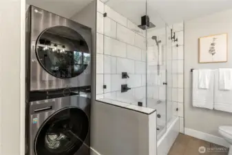 Convenient in-home laundry with modern stacked washer and dryer.
