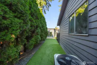 Private, fenced turf dog run—perfect for pets to play safely in a low-maintenance outdoor space.