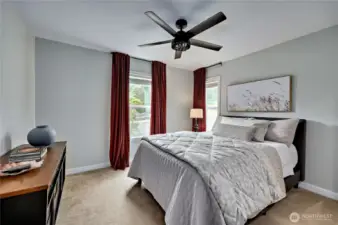 Primary bedroom with ceiling fan.