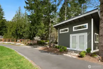 Garden shed with potting bench rolling garage door for rider lawnmower storage