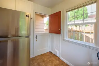 Dutch door out to side yard. To the right of the door is a spice closet, convereted from an old ironing board closet.