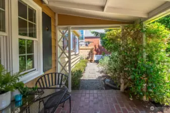 Imagine enjoying your morning coffee and pastries while on this adorable, covered front patio.