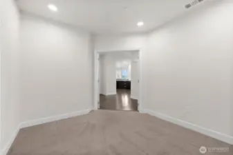 Third bedroom or den with double doors leading out to the main living area.