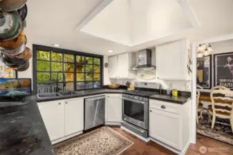 A large window to back yard and deck, plus overhead skylight