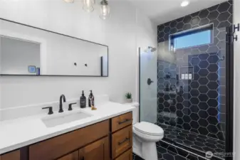 Ensuite bathroom for bedroom 3 with walk in tile shower.