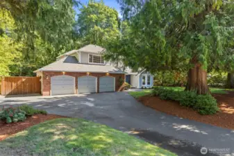 Abundant driveway and garage parking, including a double drive-through gate