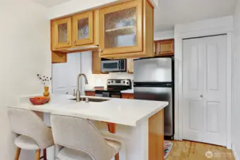 Small but mighty kitchens are the best - everything is within reach while the pantry at right provides tons of storage.