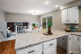 View from the kitchen to the eating space and family room.  The slider opens to the entertainment sized deck.