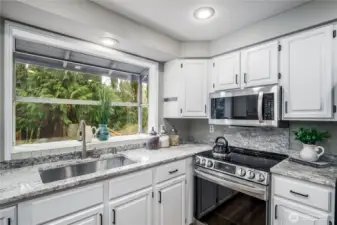 Lots of light with the garden window.  Notice the undermount farm sink and stainless appliances.