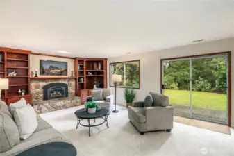 Family room features a slider to the back patio and scenic views of the woods behind the backyard.