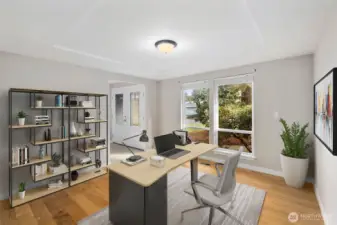Virtually staged home office or flex room near the entry with hardwood flooring and natural light in this Puyallup two-story home.