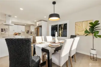 Here is view of good sized formal dining room looking back to large kitchen with lots of stylish colors and designs to enjoy here