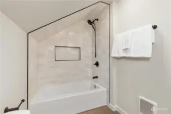 Here is another view of primary bathrooom with large glass tiled shower and oil rubbed bronzed shower fixtures