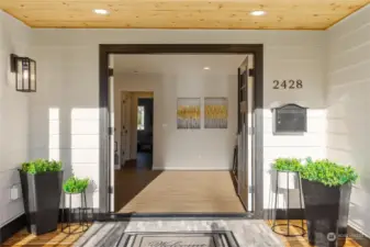 Stylish view of your new front entry of home with french doors covered front porch with recessed lighting and pine wood sofets to sit enjoy sunny afternoons on new front deck.  Come and see everything new inside