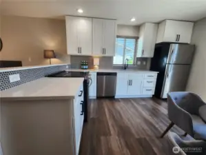 Stainless appliances and slider out to deck