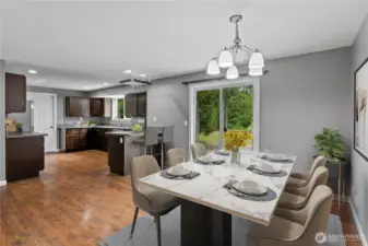 Kitchen open to dining room This photo is virtually staged