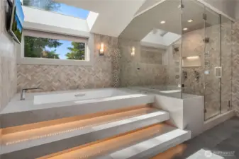 Twin shower heads and a huge tub in the primary bathroom
