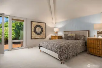 Bedroom on the main floor with vaulted ceilings, private entrance and shared 3/4 bath