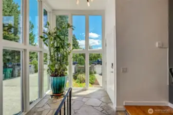 Split Entry Way with Floor to Ceiling Triple-paned Windows. Slate Flooring adds to the Charm and Style.