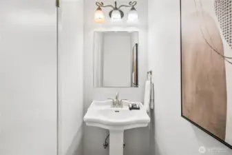 Half-bath with pedestal sink near the family room