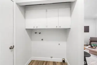 Laundry area with storage cabinets