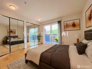 Primary suite with dual mirrored closets, a private balcony