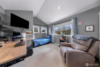 The room provides an open, comfortable layout with space for work, reading, or relaxation. Bright windows and neutral finishes create a flexible environment that can be tailored to your needs.