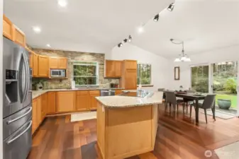 Beautiful, updated gourmet kitchen designed for entertaining, opening effortlessly to the dining room.