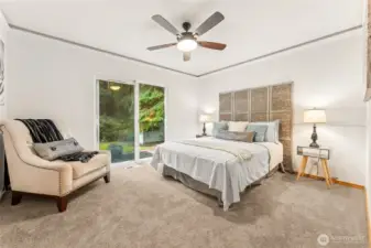 Your private retreat: primary suite with ensuite, walk-in closet, and sliding door to the patio and backyard.