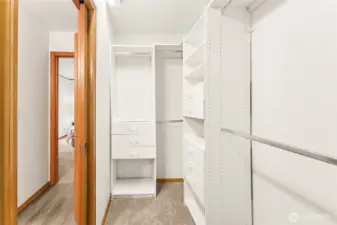 The custom walk-in closet offering plenty of shelves and drawers for effortless organization.