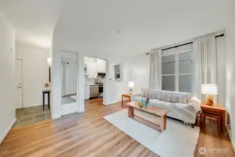 The great room layout feels airy and welcoming, with windows on two walls filling the space with natural light