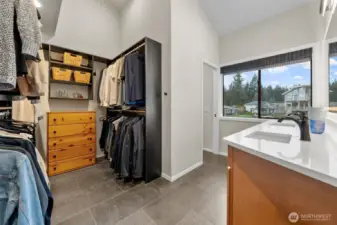 Walk-in closet and bath vanity in the primary suite.