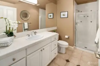 Three quarter hallway bath with tile floors and tile shower.