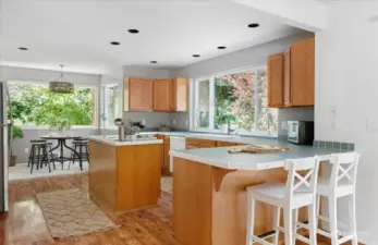 Easy way for guest chefs to stay out of the kitchen is to have them sit at the kitchen counter! More formal seating is at the back window.